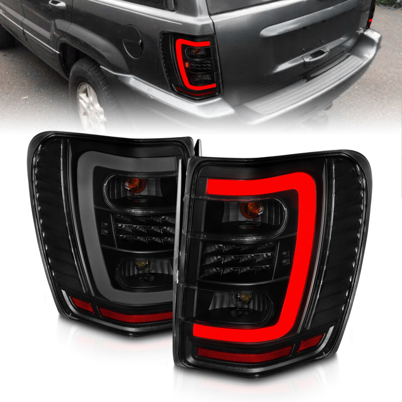 ANZO 1999-2004 Jeep Grand Cherokee LED Tail Light Set with Light Bar and Smoke Lens - Black Housing