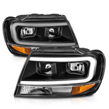 ANZO 99-04 Jeep Grand Cherokee Crystal Headlights with Light Bar, Black Housing, Clear Lens – Pair