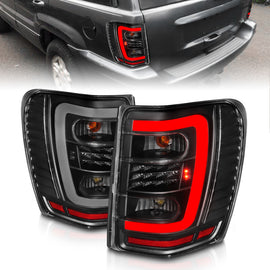 ANZO 1999-2004 Jeep Grand Cherokee LED Tail Light Set with Light Bar, Black Housing & Clear Lens
