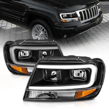 Load image into Gallery viewer, ANZO 99-04 Jeep Grand Cherokee Crystal Headlights with Light Bar, Black Housing, Clear Lens – Pair